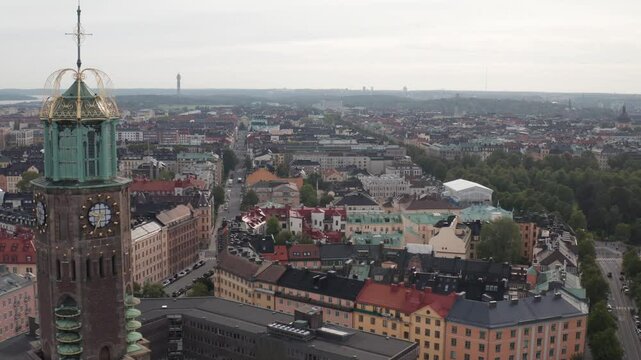 Engelbrektskyrkan in &Ouml;stermalm, Stockholm, Sweden during cloudy sunset in the summer. Aerial shot pushing past the church showing skyline, buildings and rooftops.
