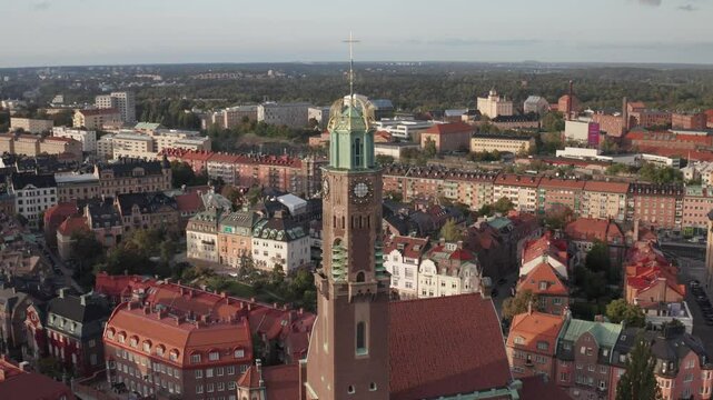 Engelbrektskyrkan in &Ouml;stermalm, Stockholm, Sweden during evening. Aerial shot orbiting left with the church in foreground and skyline in the background.