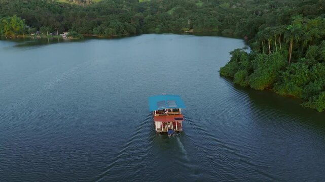 Follow shot of Tour ferry at Hatillo dam, Cotui, Province of Sanchez Ramirez, Dominican Republic