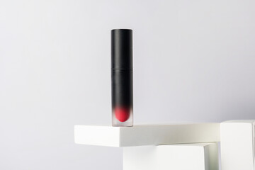 Mockup of black blank thin tube - mascara, lip gloss, gel, eyeliner, oil, etc. Cosmetic package with stylish props on white background. 