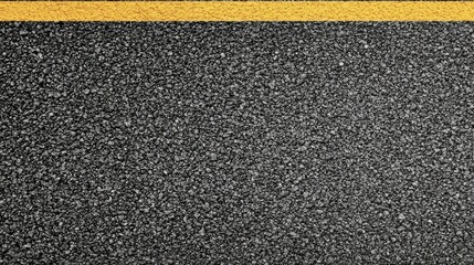 Close-up of textured asphalt road with yellow line dividing surface for transportation concept