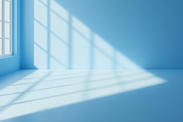 Obraz premium Sunlight streams through a window into a minimalist blue room.