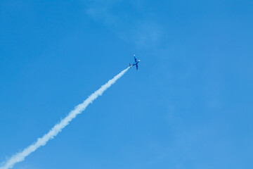 L-29 Jet Plane Flying with Contrails on Blue Sky
