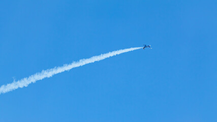 Jet Plane with Contrails on Blue Sky