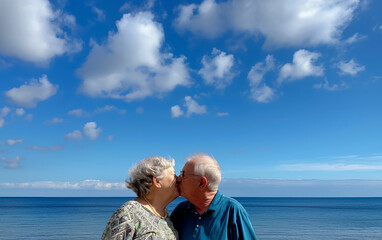 Fototapeta premium Senior Couple Kissing by the Ocean – Romantic Vacation and Lifelong Love