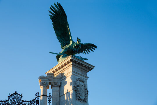 Statue of mythological Turul bird in Budapest at sunset