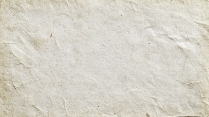Fototapeta premium A beautiful piece of textured paper lies flat, displaying a warm, off-white hue mixed with gentle creases. Perfect for artistic endeavors, it embodies a vintage feel that enhances creativity