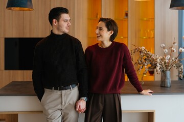 Couple enjoying time together in modern kitchen with stylish decor
