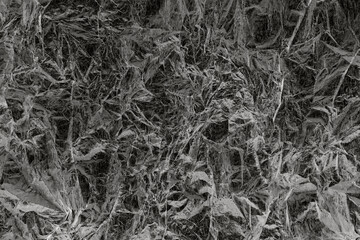 Abstract textured pattern resembling crumpled paper in monochrome tones