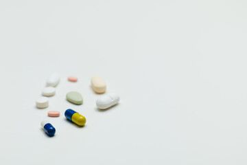 colored pills and capsule on white background