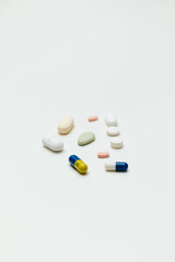 colored pills and capsule on white background