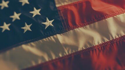 A close-up of the American flag, showcasing its detailed stars and stripes with a golden hue, symbolizing patriotism