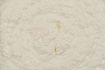 A top-down view of a rectangular aluminum foil container on a yellow background, showcasing its textured surface and reflective material