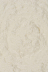 A top-down view of a rectangular aluminum foil container on a yellow background, showcasing its textured surface and reflective material