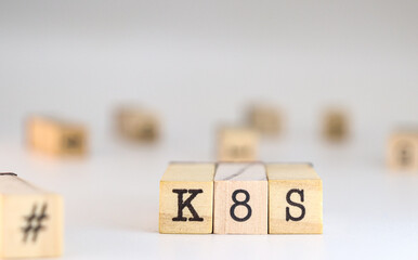 Kubernetes concept. K8S acronym written on wooden cubes isolated on white background with space for text
