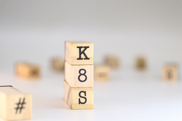 Kubernetes concept. K8S acronym written on wooden cubes isolated on white background with space for text