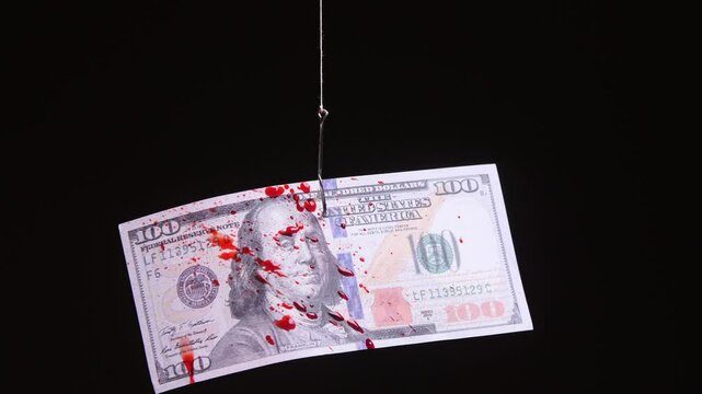 Bloody one hundred dollar bill hooked as bait on fishing line, pierced by a fishing hook