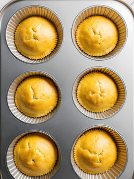 Unbaked spinage and cheese filling in puff pastry dough shells in muffin tin