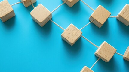 A mosaic of wooden blocks, connected in a harmonious network, rests on a serene blue backdrop, symbolizing the strength and collaboration of teamwork.