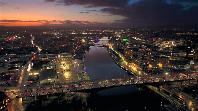 Sunset night aerial city Glasgow Scotland and river Clyde rush hour traffic