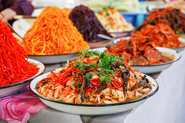 Stand with different fresh salads at Chorsu Bazaar, a market in Tashkent, Uzbekistan