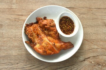 grilled chicken tight stabbing wooden stick on plate dipping with spicy sauce 