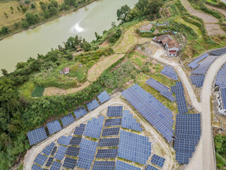 Aerial view of a Chinese rural house with a large array of solar panels nearby