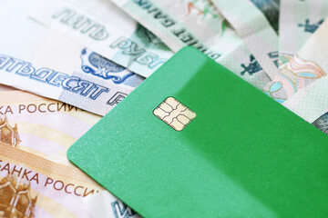 Green bank card and Russian cash