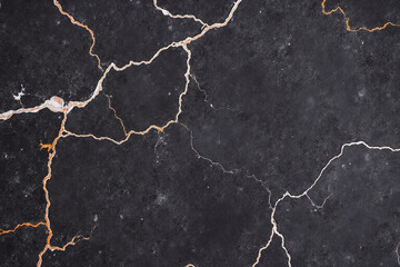 Obraz premium close up of a black marble wall with orange veins