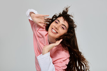 Fototapeta premium Joyful young woman expressing happiness in trendy fashion with vibrant colors