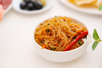 Korean rice noodles with sauce and spices. Traditional Asian spicy cuisine.