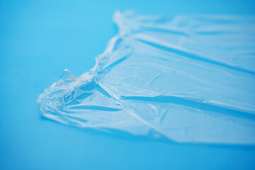 Transparent stretch film for packaging on a blue background. material for storing food and objects. household trifles.