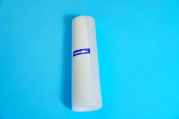 Roll film for a product vacuum sealer machine on a blue background. long-term storage of products at home.
