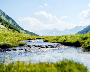 Fototapeta premium A serene landscape featuring a flowing stream surrounded by lush green grass and majestic mountains under a bright blue sky.