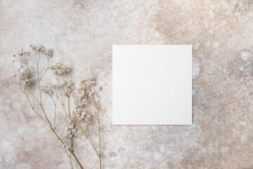 Square wedding invitation mockup with dry gypsophila flowers decor, blank card mock up with copy...