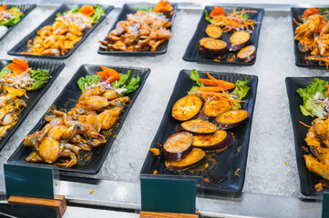 Asian seafood, meat and vegetable dishes at the buffet at the Vietnamese self-service restaurant in hotel in Asia in Vietnam