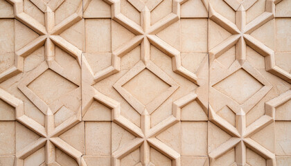 Naklejka premium Intricate geometric patterns on textured stone wall create stunning visual