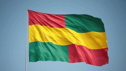 Obraz premium Vibrant Cameroonian Flag Waving Against Clear Blue Sky Background