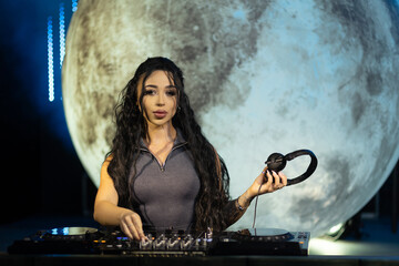 Female DJ Freestyling a Live Set with Moon Backdrop at Night