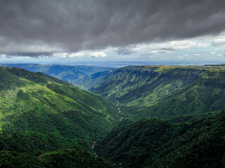 A striking drone shot of a vast ditch covered by heavy dark clouds, enhancing the depth and mystery...