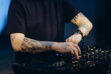 Young DJ Mixing Music on Professional Audio Console at Nightclub Event