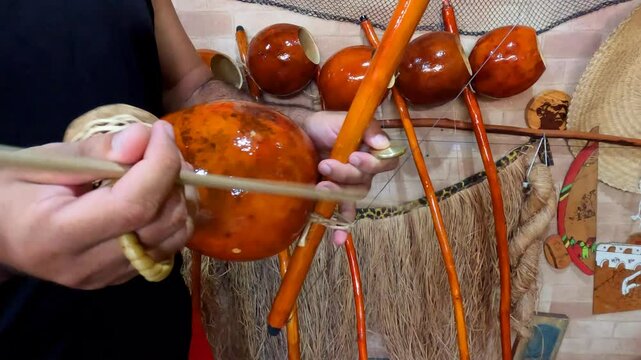 Rio de Janeiro - Rio de Janeiro - Brazil - February 23, 2025: Capoeira Master playing the Berimbau musical instrument in Rio de Janeiro, Brazil.