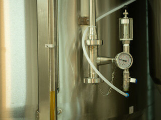 A small industry brewery's brewing tanks in a brewery that produces craft beer