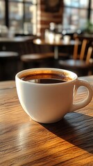 Obraz premium A cup of coffee on a warm wooden table in a warm atmosphere