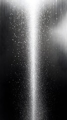 A vertical abstract design shows shimmering light on dark background