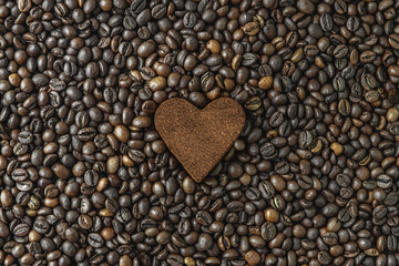 coffee beans and ground coffee in the heart shape close up top view