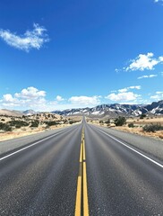 Naklejka premium Wide empty highway asphalt road stretching into the distance under a clear blue sky with gentle mountain landscape in the background, vast, landscape