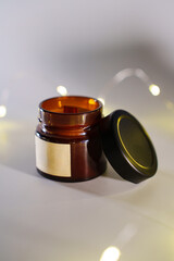 Scented candle with wooden wick in a dark glass jar. Hand-made candles made of natural soy wax with aroma fragrance.