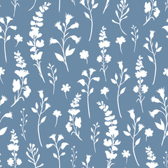 White seamless pattern of silhouettes of wildflowers and their leaves lying vertically on a blue background