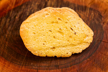 a piece of aged cheese on a wooden platter